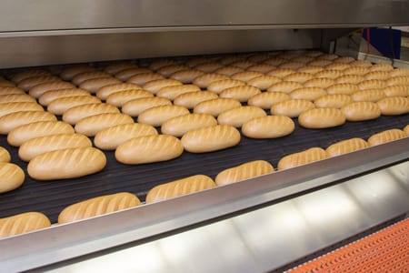 Loaves of bread baking in an industrial oven