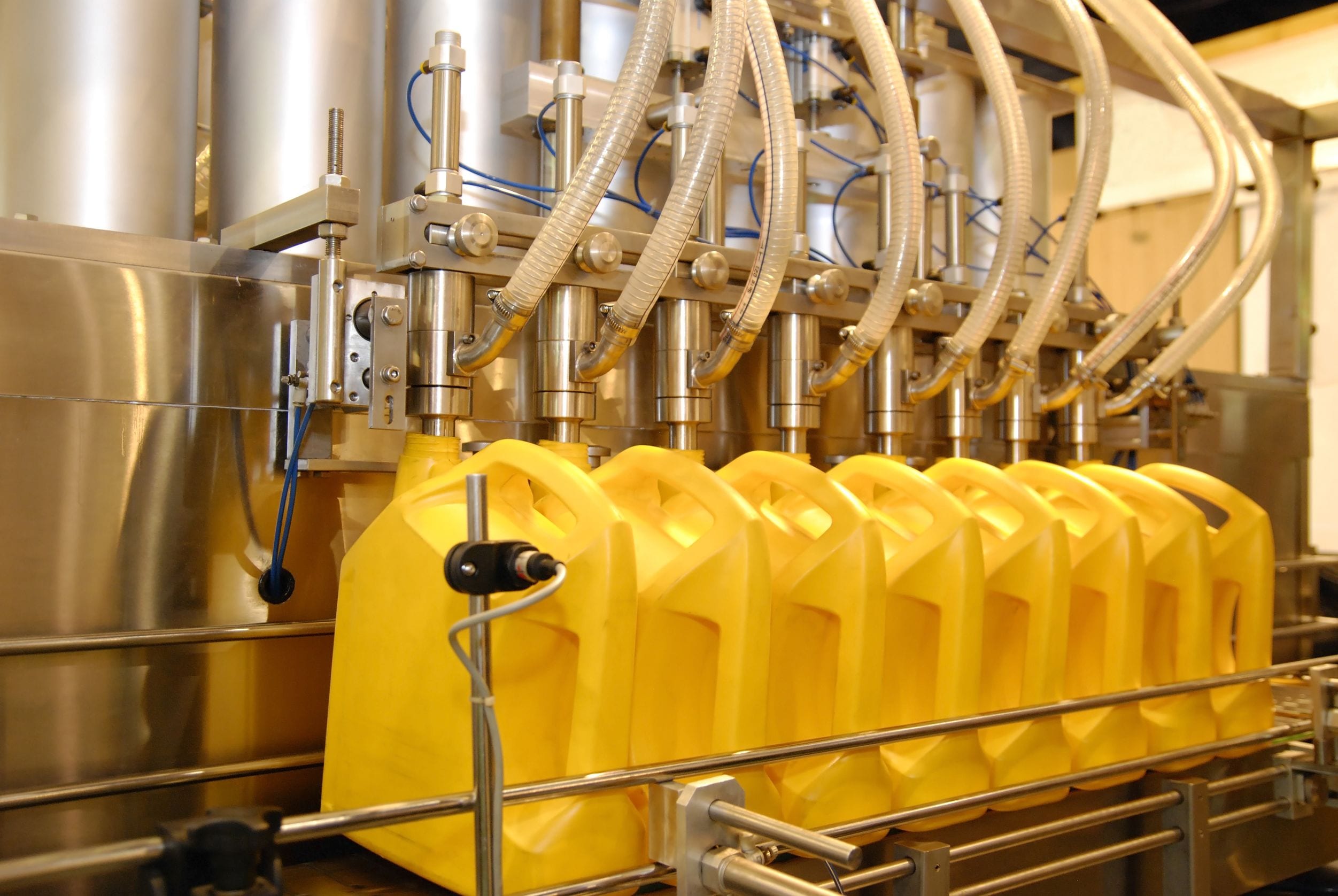  Liquid filling machines filling bottles with corn oil on the production line